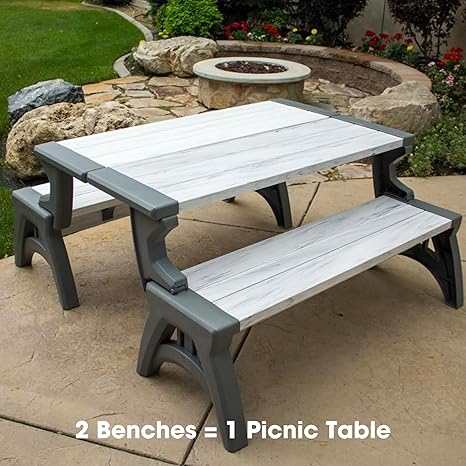 Grey picnic table by a fire pit