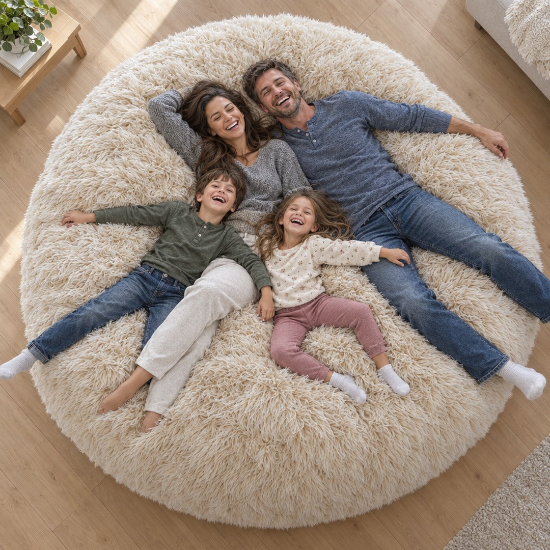 Top-down view of a family of four lying together on the bean bag