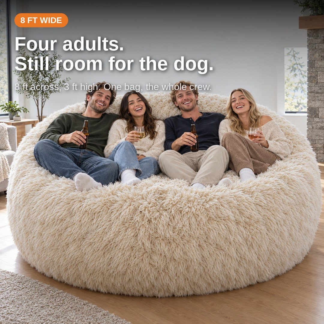 Four adults sitting side by side on the 8 ft bean bag