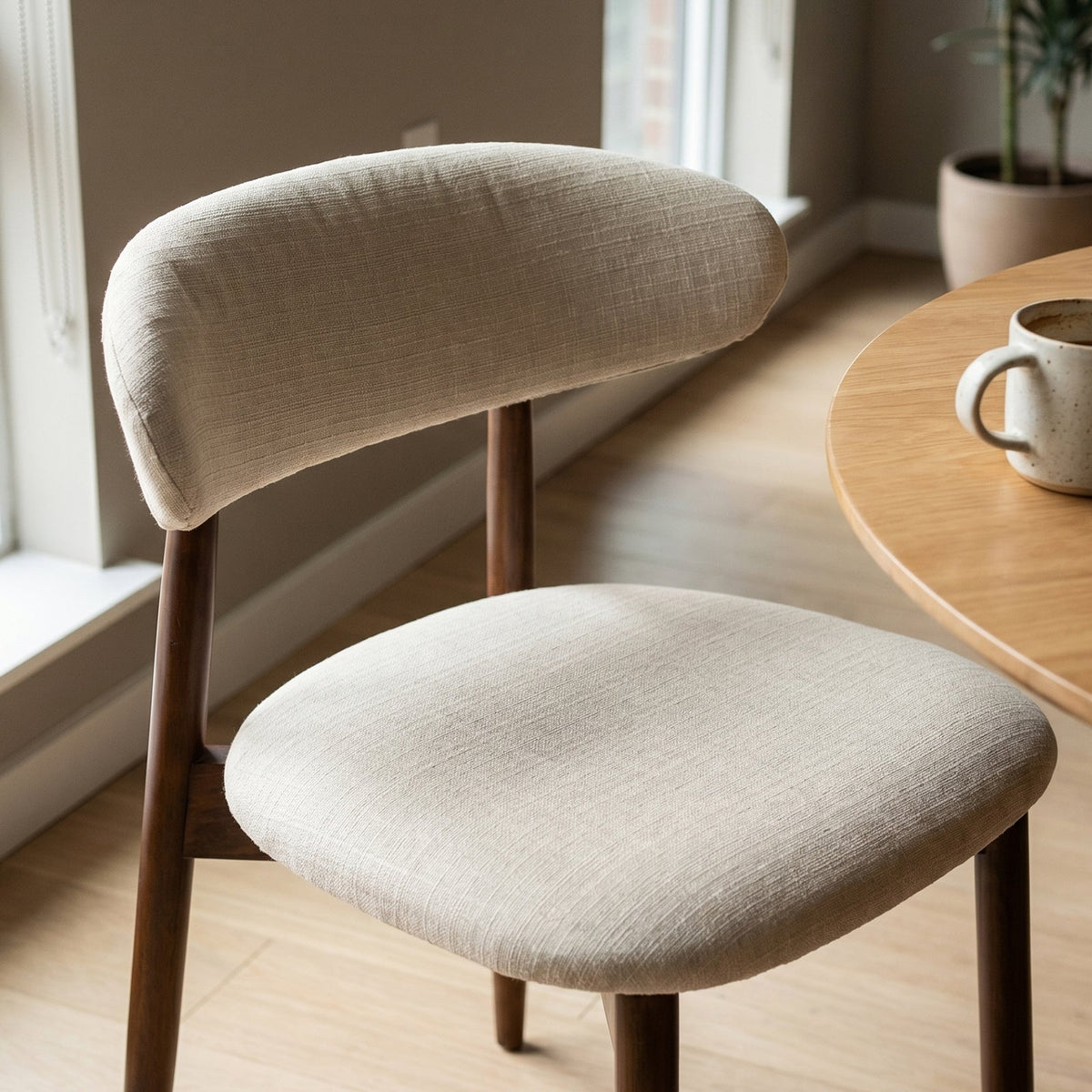 Close-up of the padded seat and wooden legs