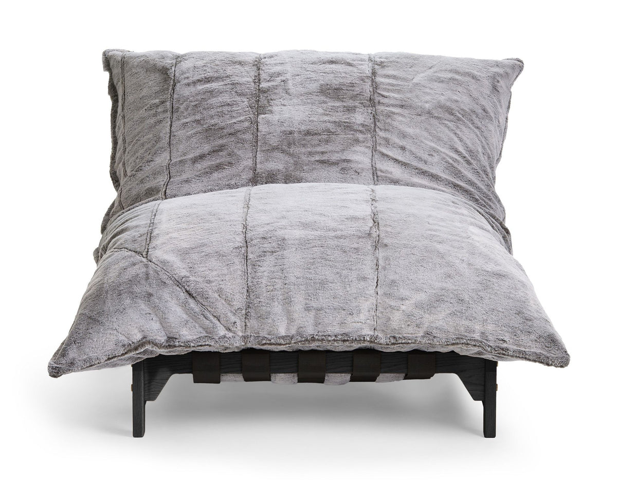 Oversized charcoal faux fur pillow lounge chair on a black wood frame