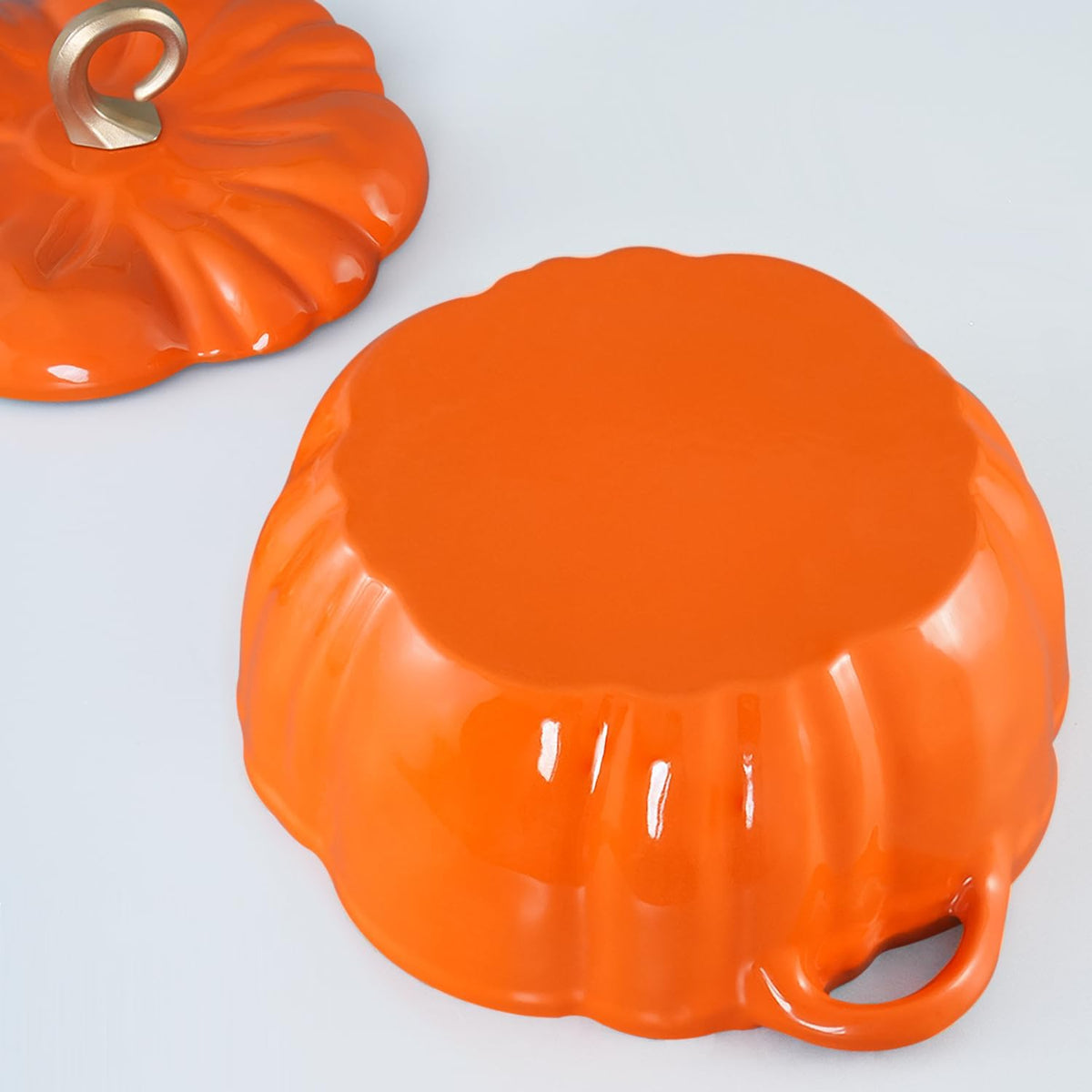 The pumpkin-shaped base of the pot