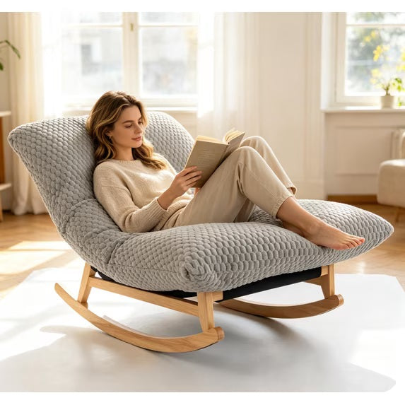 The papasan rocking chair in Light Gray, with someone reading in it